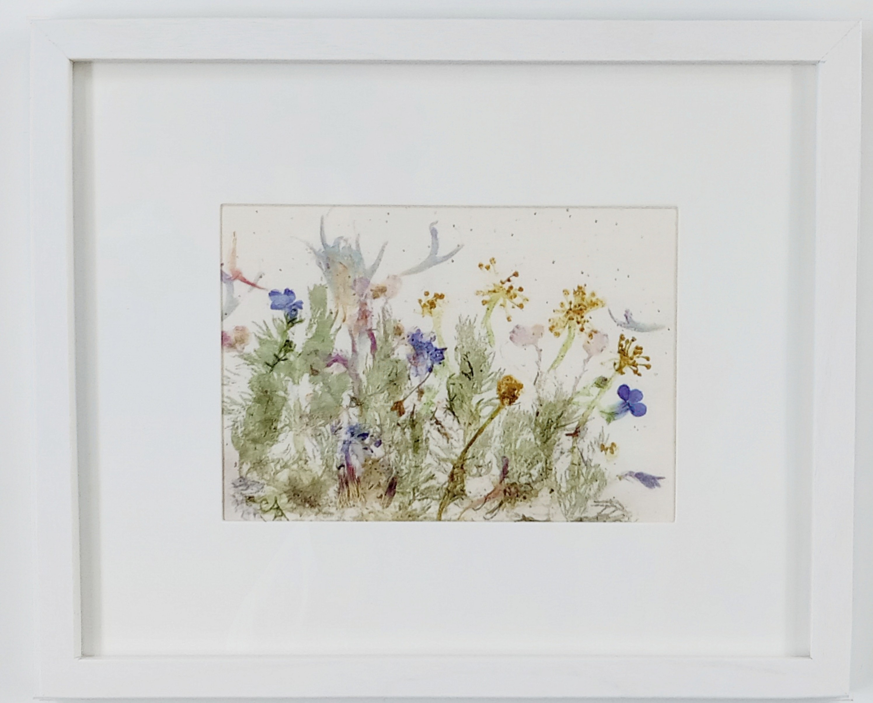 Magical Meadow I — framed botanical pounding artwork on mordanted combed cotton with a meadow of blue, yellow, pink, and green flowers